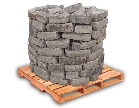 Stack of gray stone pavers on a wooden pallet