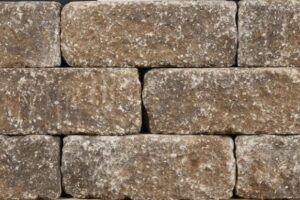 Stacked beige stone blocks with rough, weathered surfaces