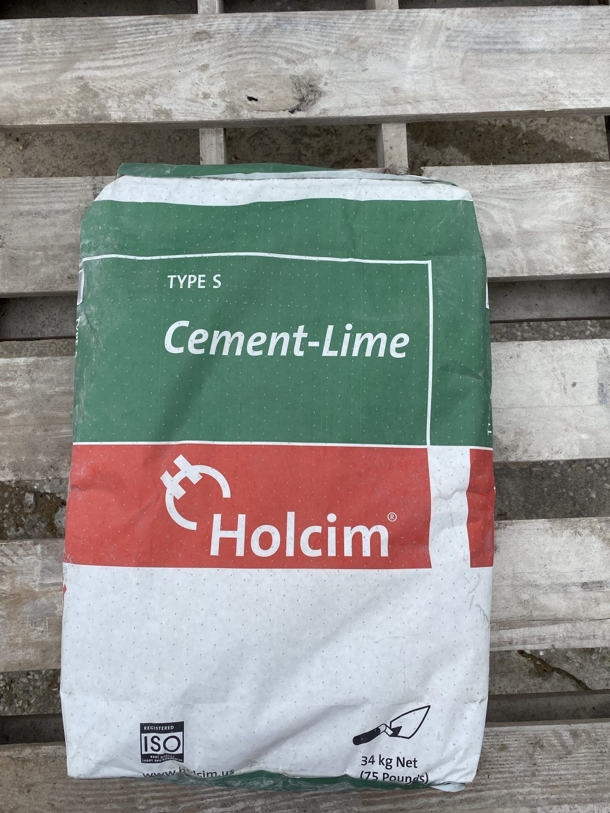 Holcim Type S cement-lime bag on a wooden pallet, white and green packaging
