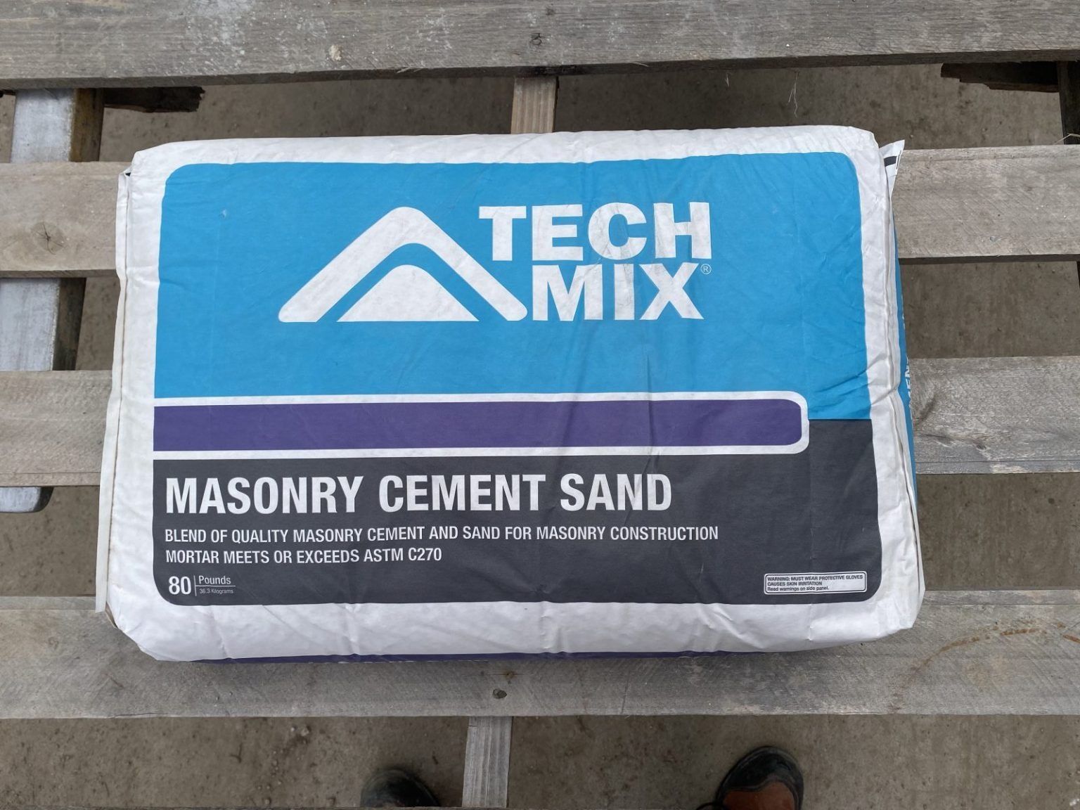 Blue Tech Mix masonry cement sand bag on a wooden pallet