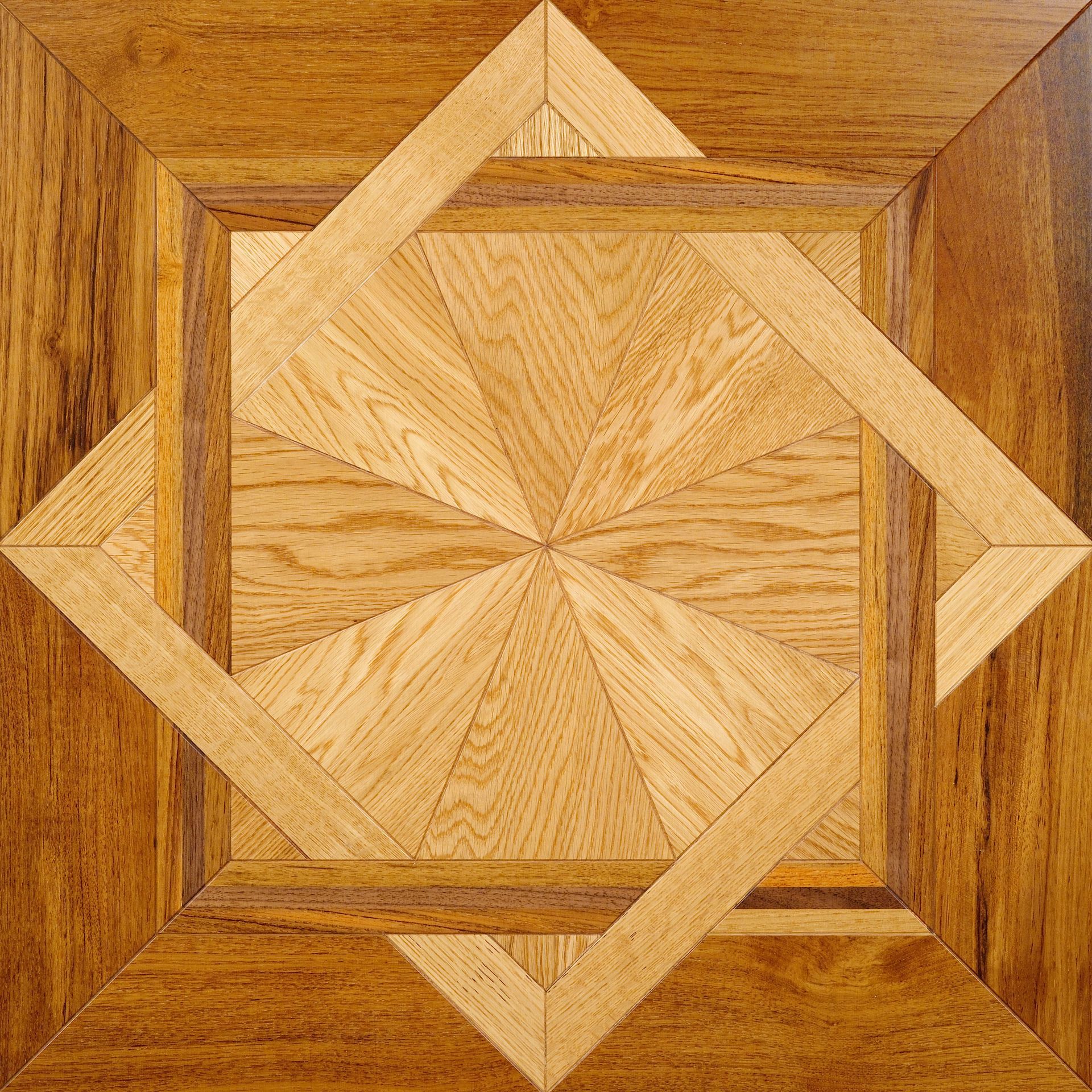 Wooden inlaid floor tile with geometric pattern. Light and dark wood arranged in a square within a square design.