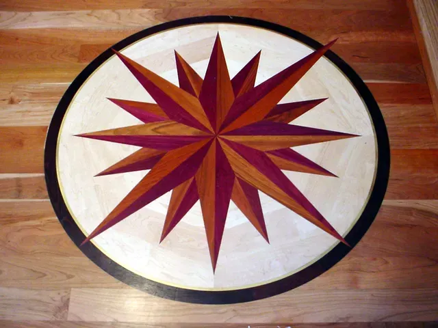 Wood floor with a compass rose design in various wood tones.