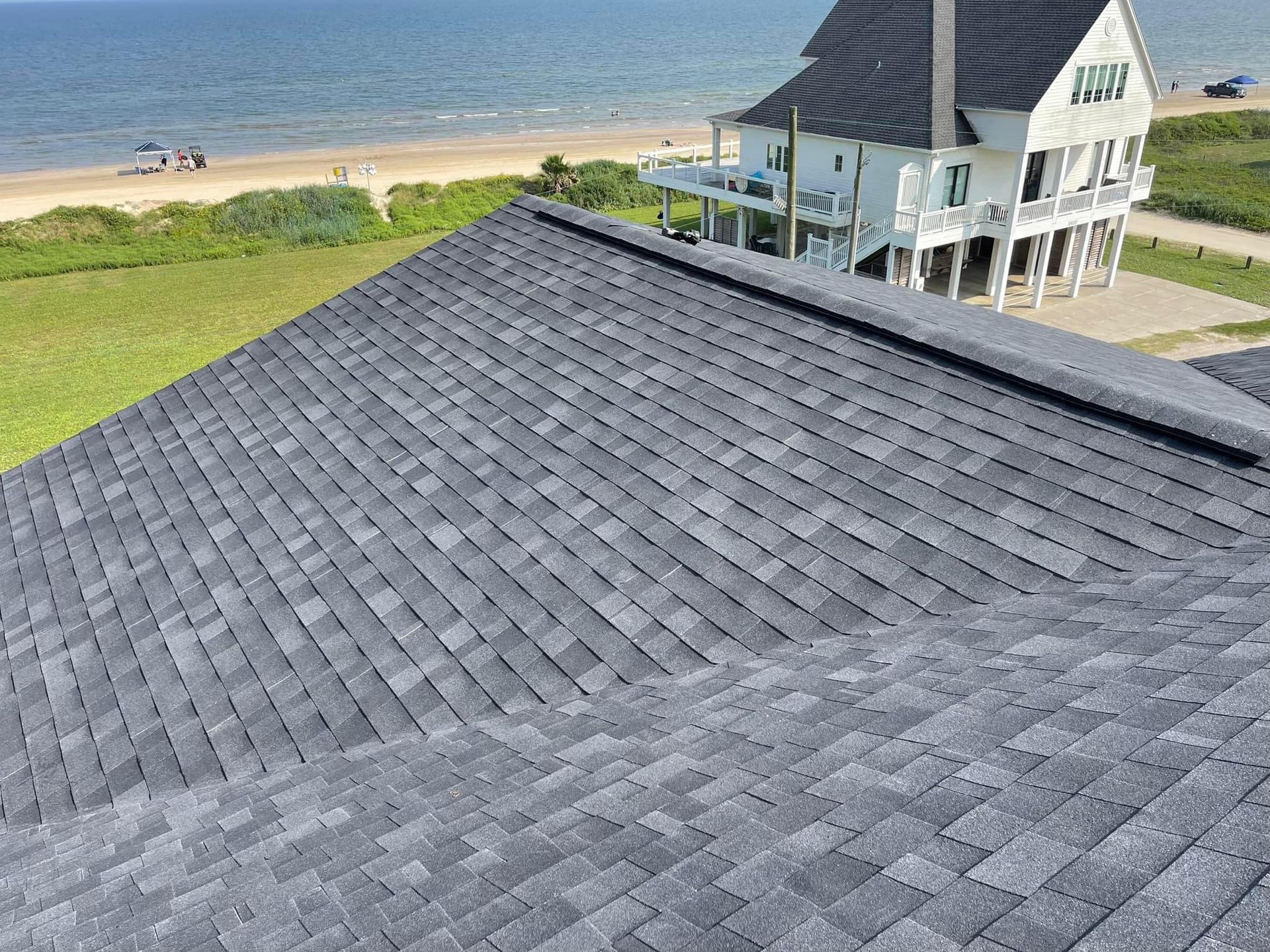 The roof of a house with a view of the ocean.