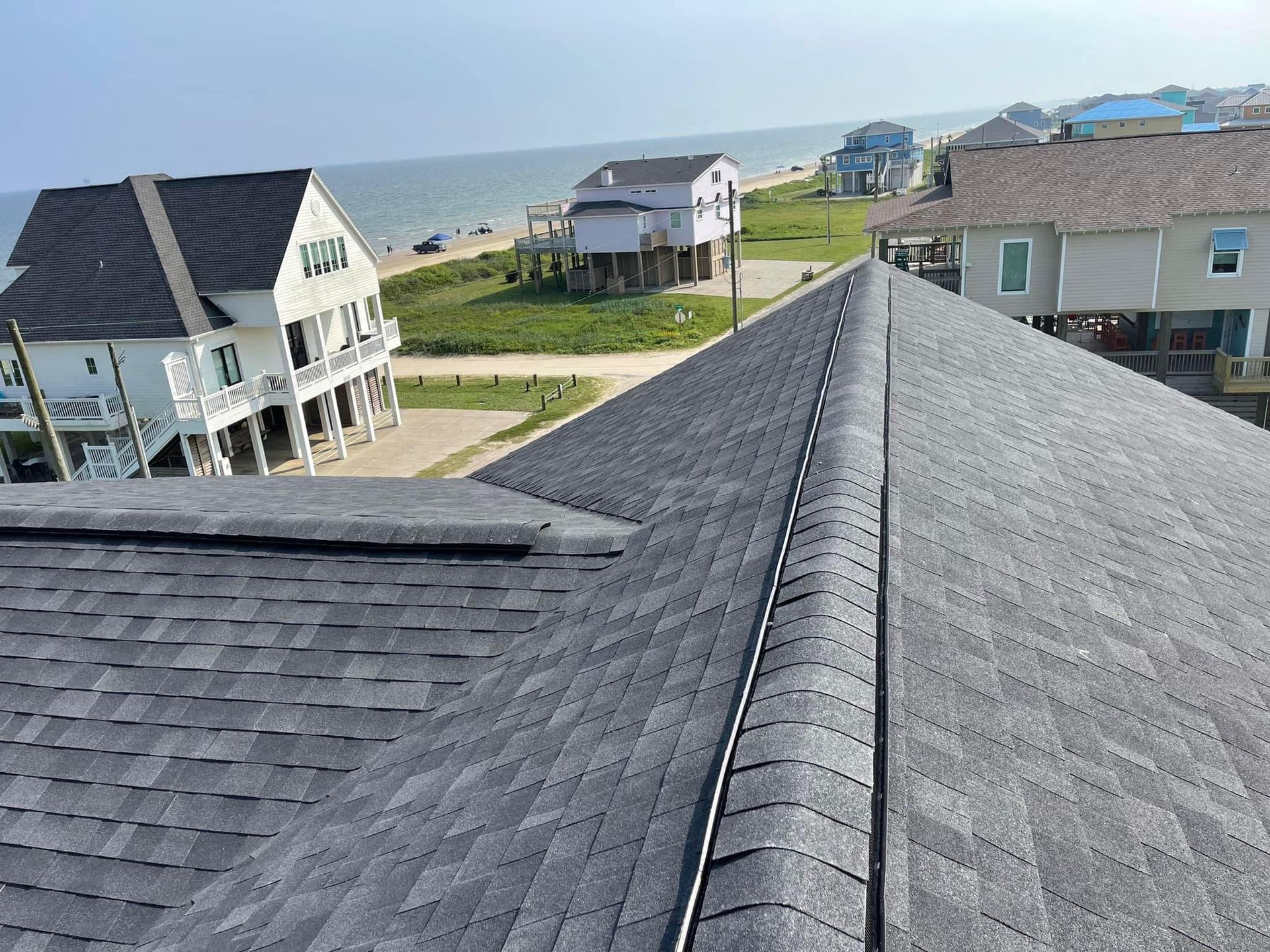 A roof of a house with a view of the ocean.