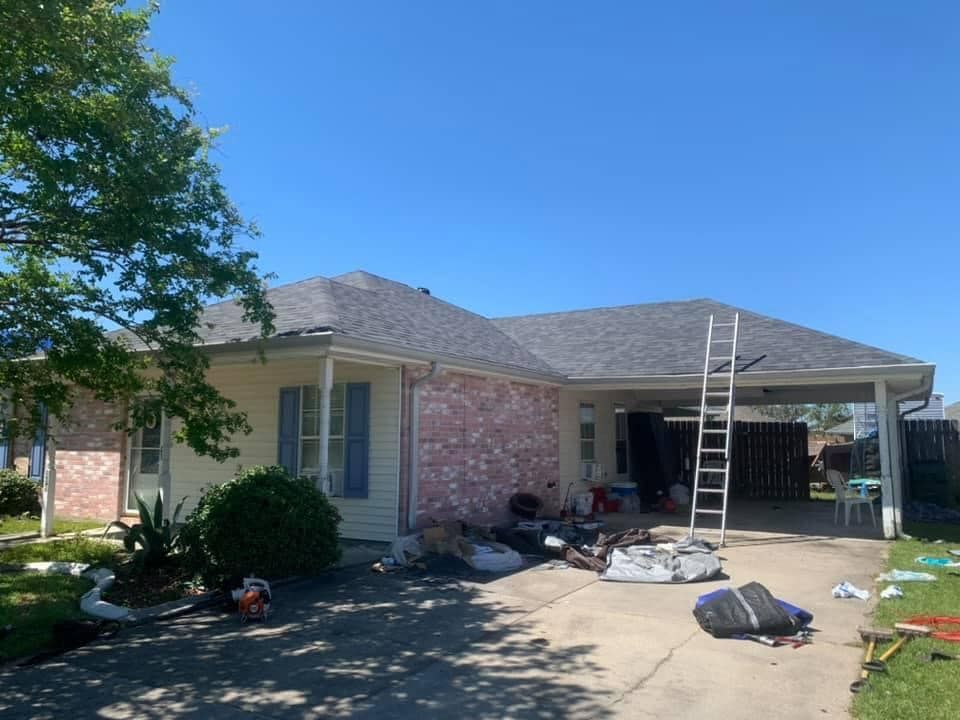 A house with a ladder in front of it is being remodeled.
