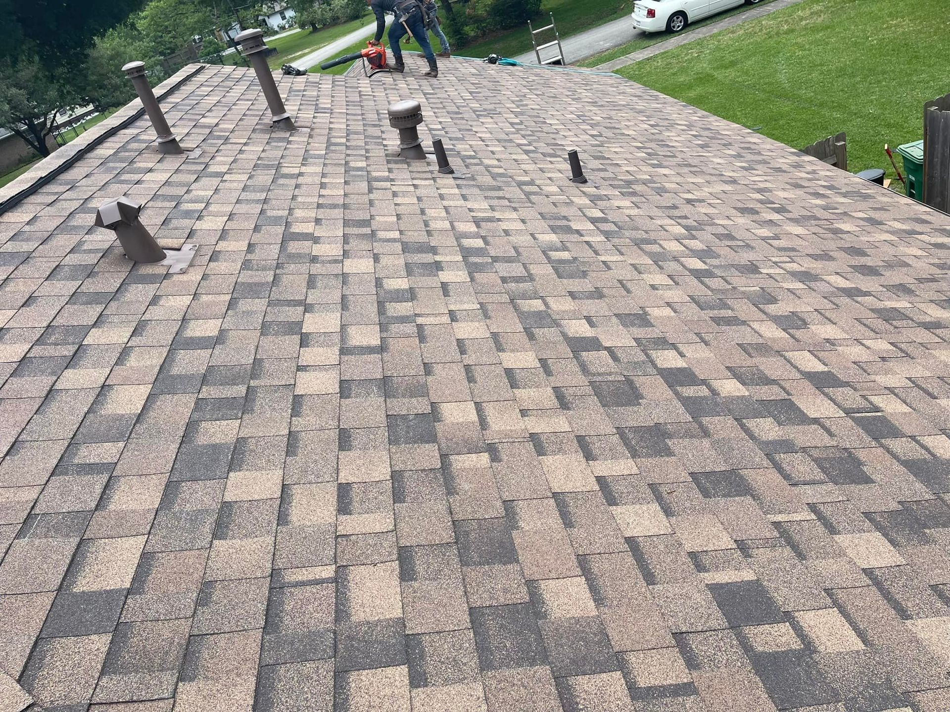 A man is standing on top of a roof.