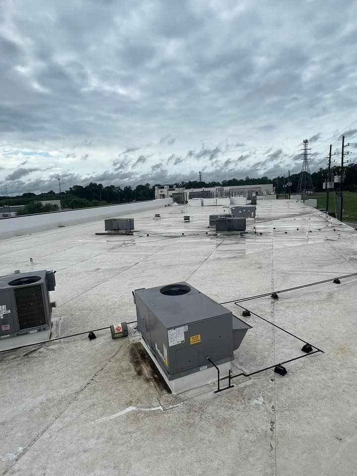 The roof of a building with a lot of air conditioners on it.