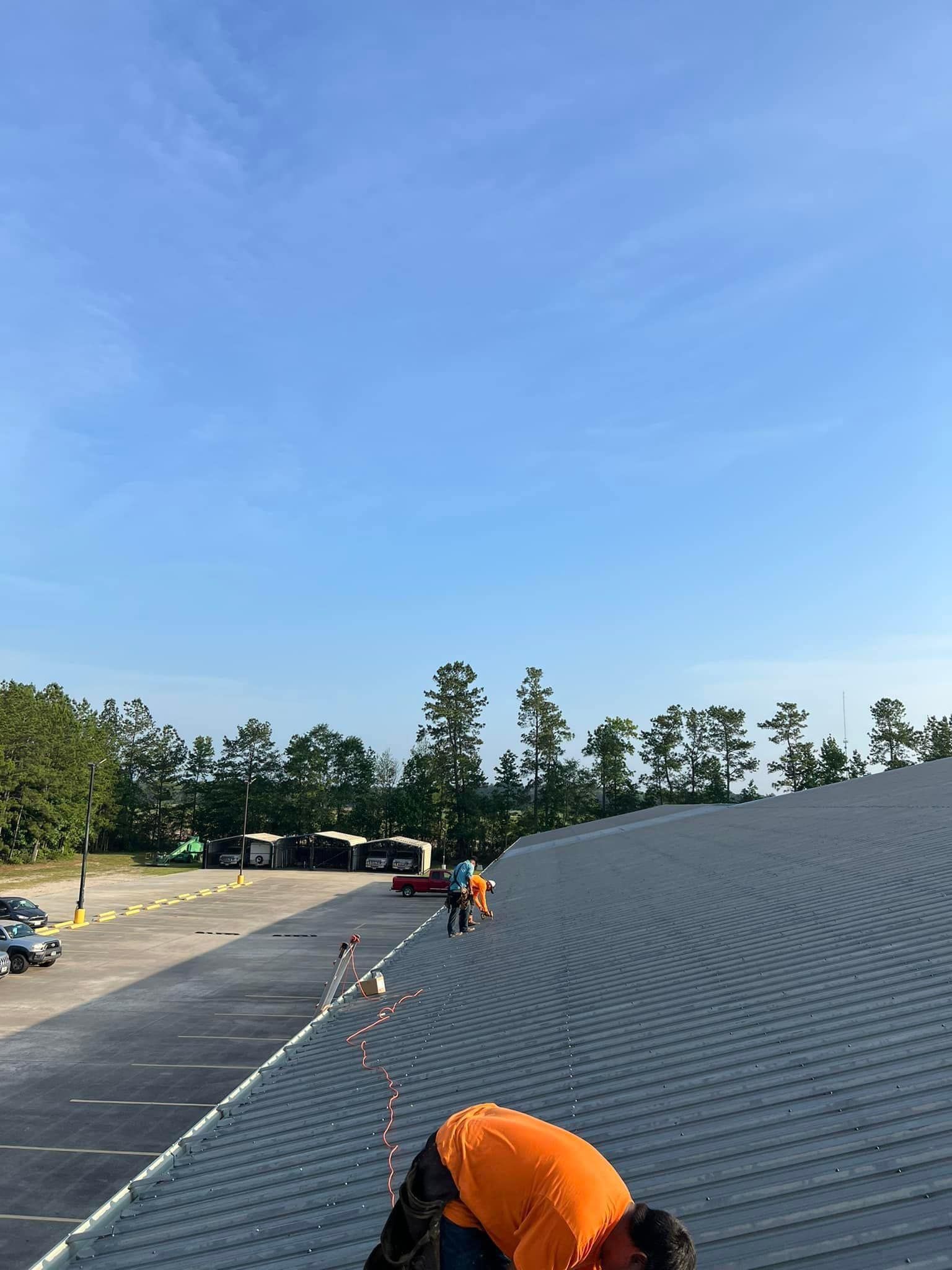 A man is working on the roof of a building.