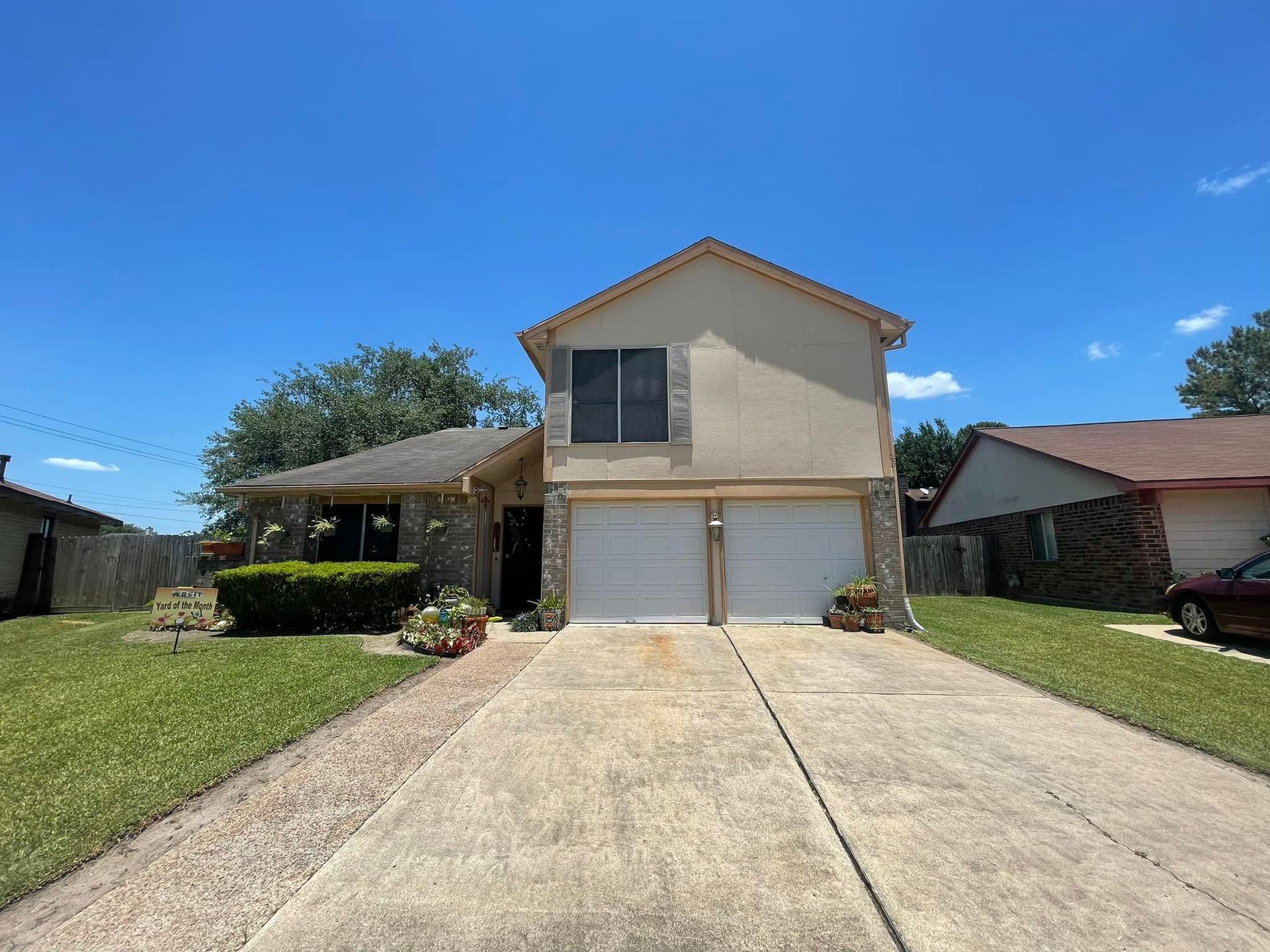 A house with a driveway and a car parked in front of it.