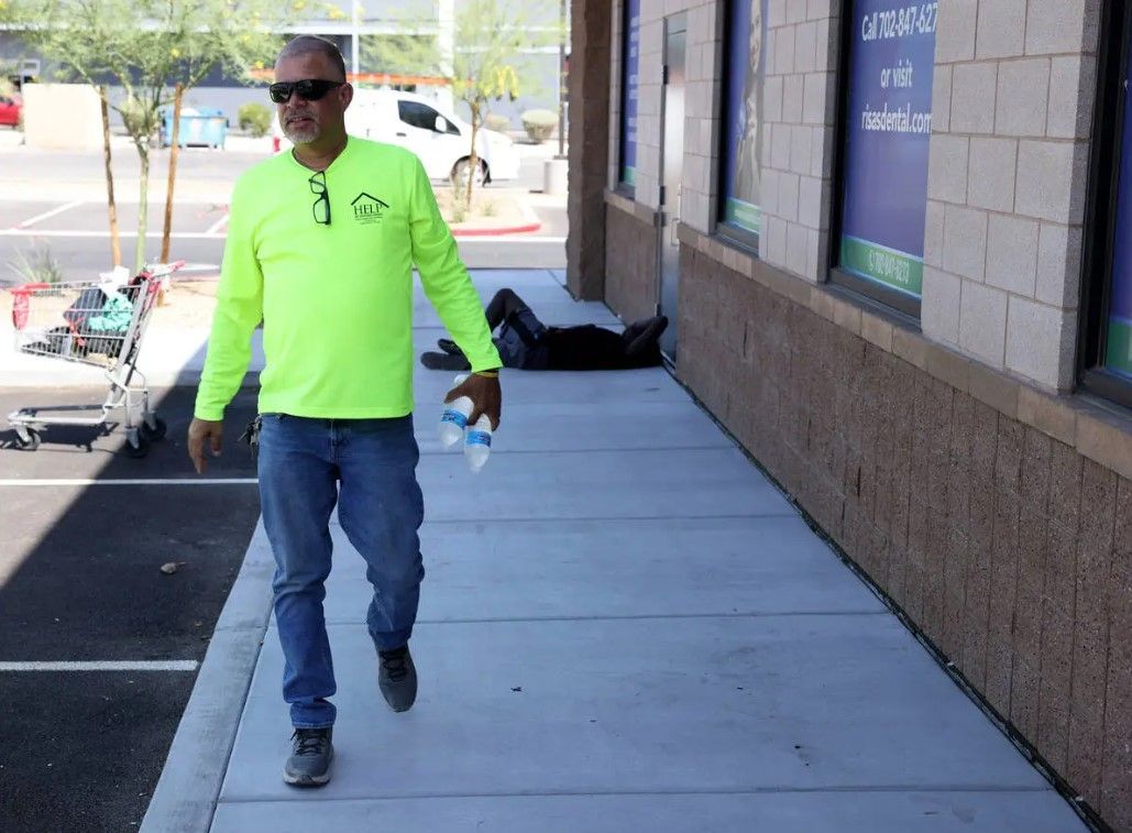 A man in a neon green shirt is walking down a sidewalk