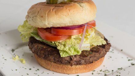 Juicy burger with tomato, lettuce, and onions