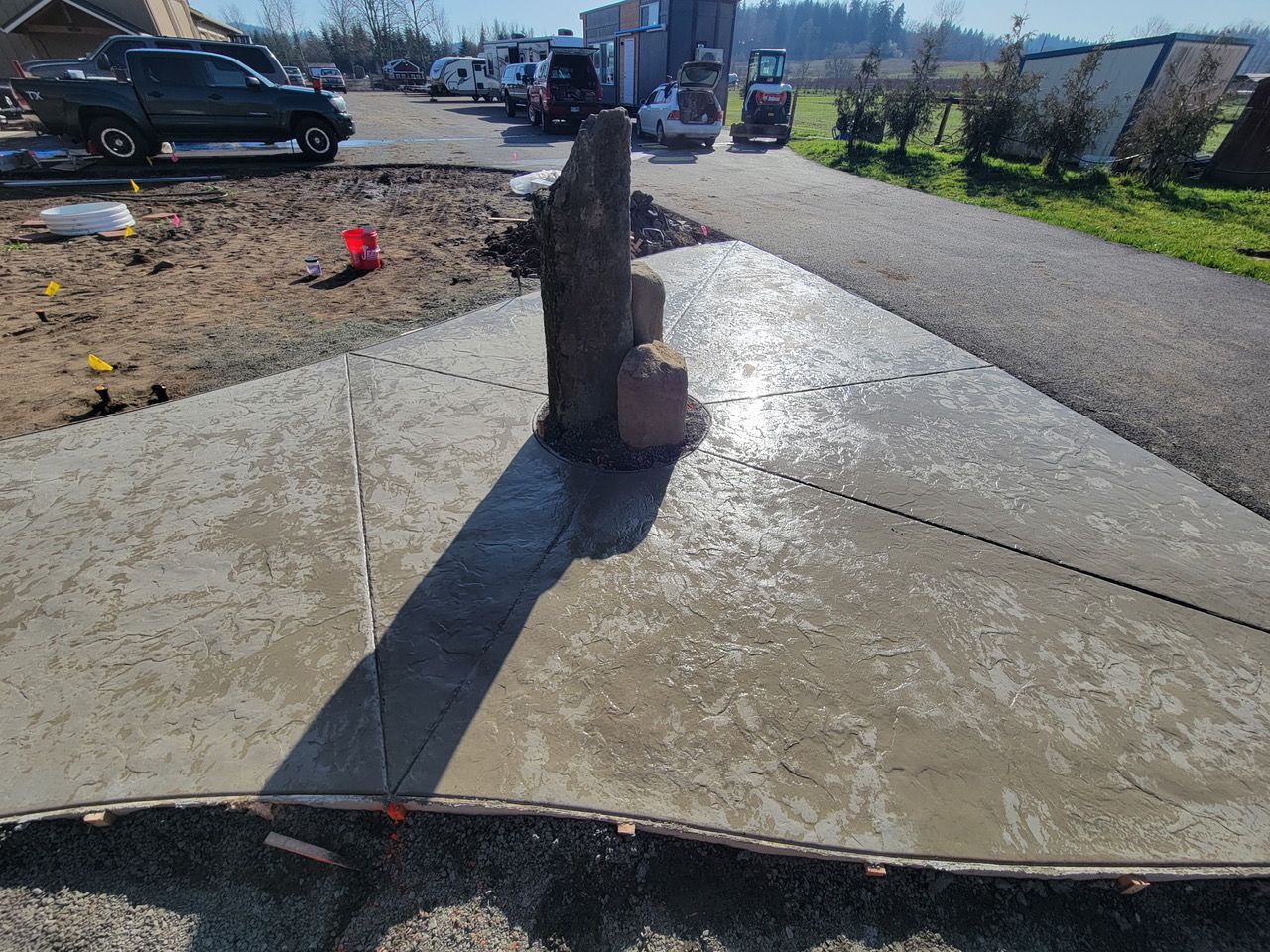Cracked sidewalk around a broken fire hydrant leaking water in a residential street.