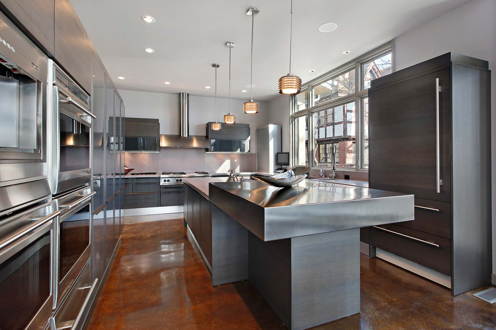 A kitchen with stainless steel appliances and a large island