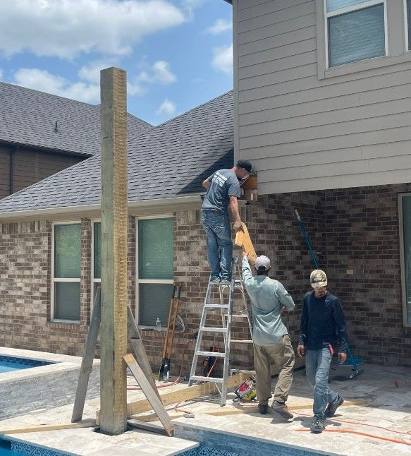 A group of men are working on the side of a house