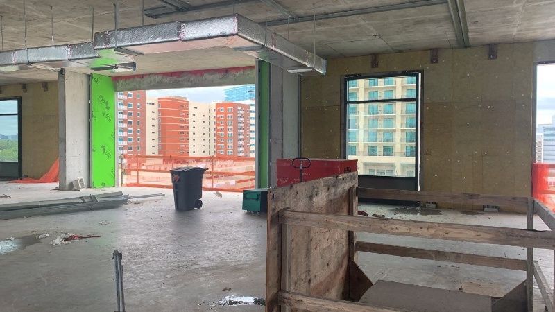 An empty room in a building under construction with a view of a city.