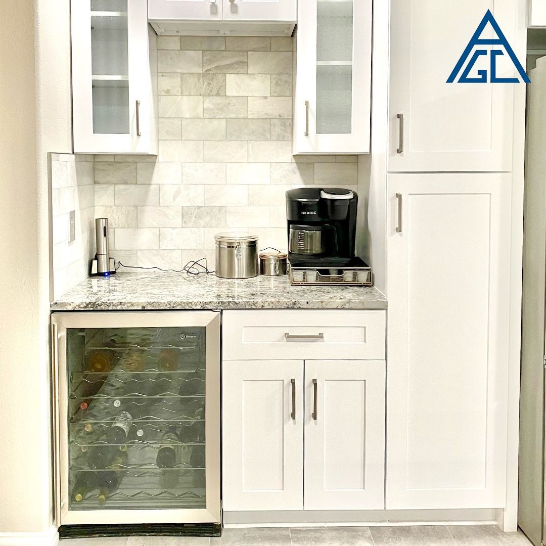 A kitchen with white cabinets and a wine cooler