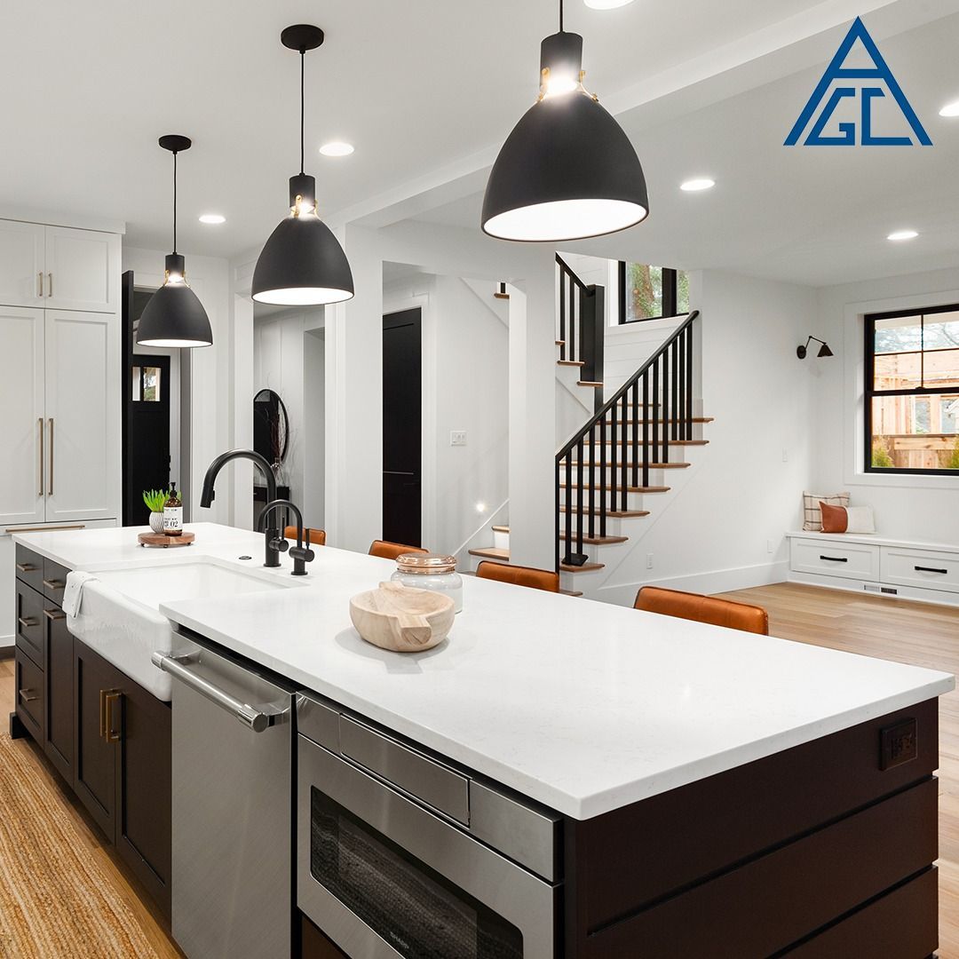 A kitchen with a large island and stainless steel appliances.