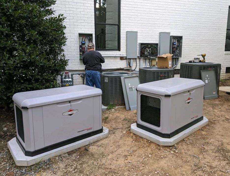 A man is working on a generator outside of a house.