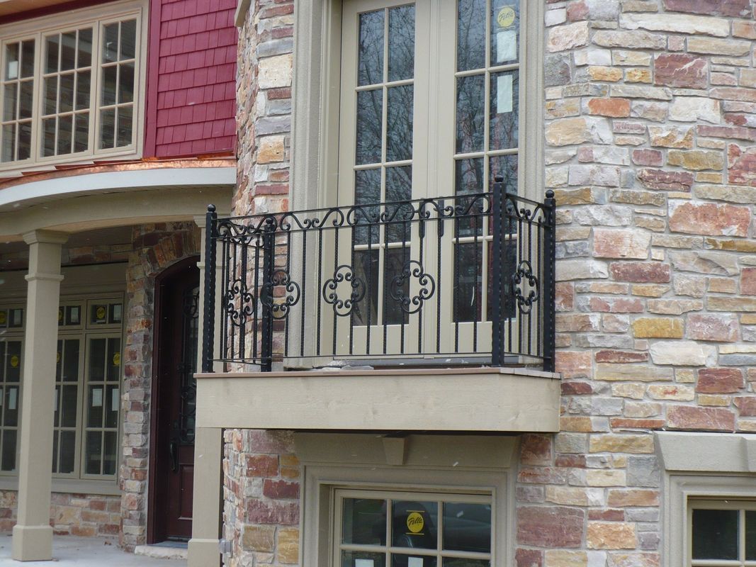 A brick building with a balcony on the side of it