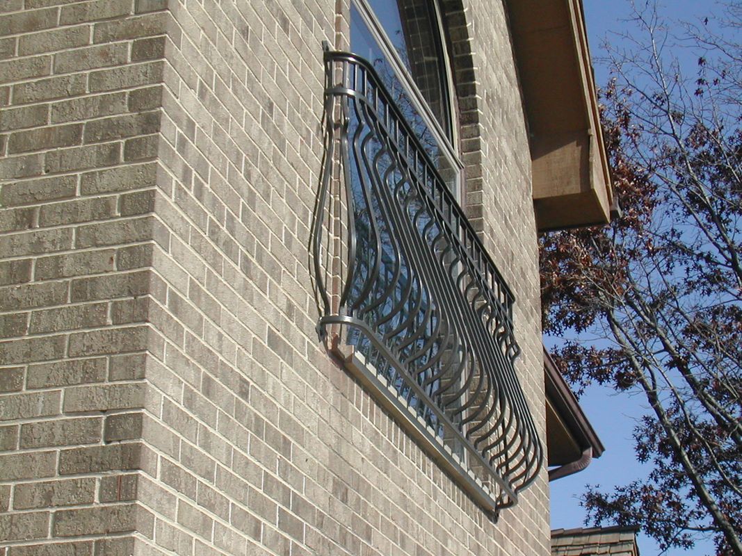 A brick building with a balcony on the side of it