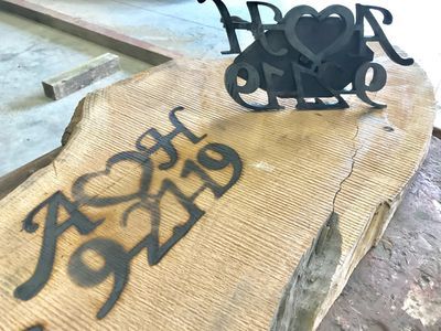 A piece of wood with a couple of letters on it.