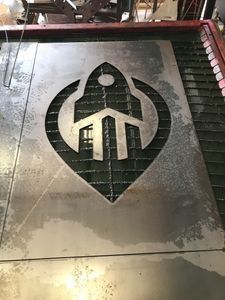 A piece of metal with a logo cut out of it.