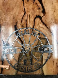 A close up of a logo on a piece of wood.