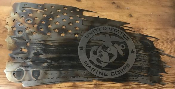 A united states marine corps flag is sitting on a wooden table.