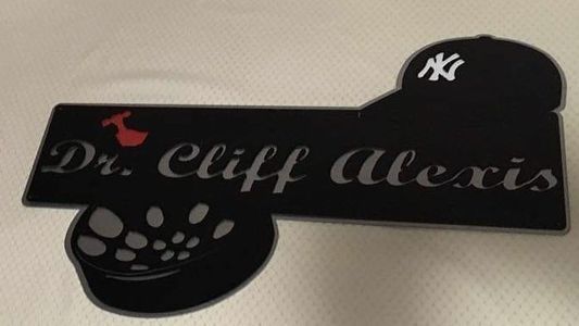 A black sign with the name dr. cliff alexis on it
