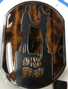 A belt buckle with a silhouette of a man and a dog on it