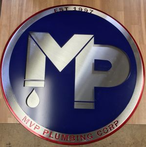 A logo for mvp plumbing corp is on a wooden table
