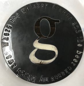 A black coin with the letter g on it