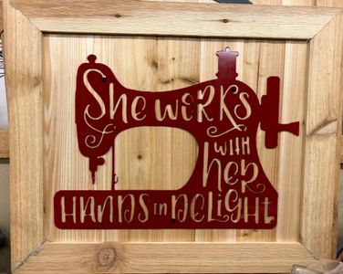 A wooden sign that says she works with her hands in delight