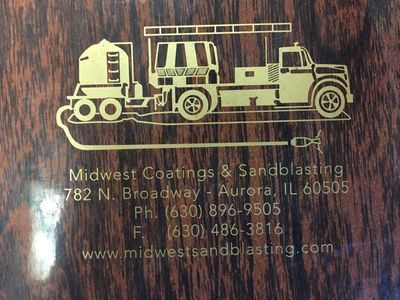 A wooden sign for midwest coatings & sandblasting