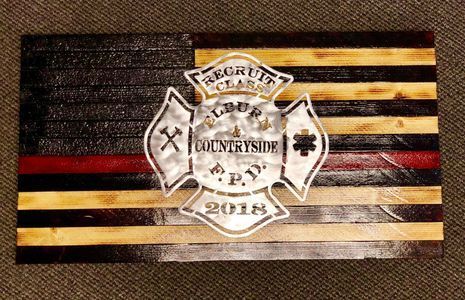 A wooden flag with a fire department logo on it.