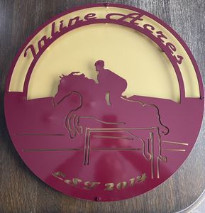 A red and yellow sign with a man riding a horse