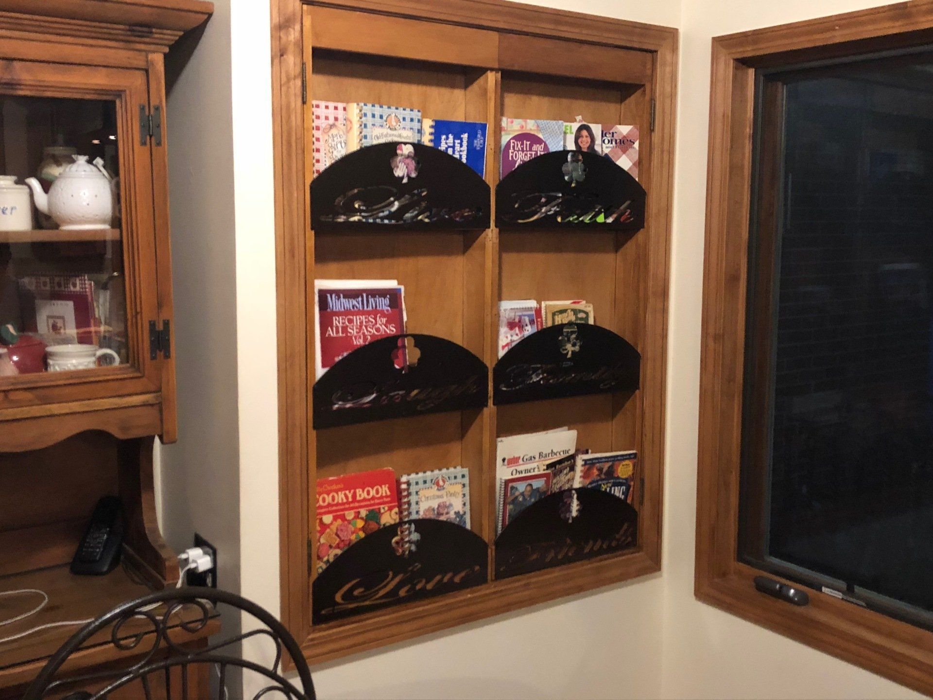 A wooden shelf with magazines on it including one that says new and next