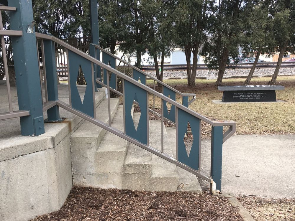 A set of stairs with a blue railing in a park