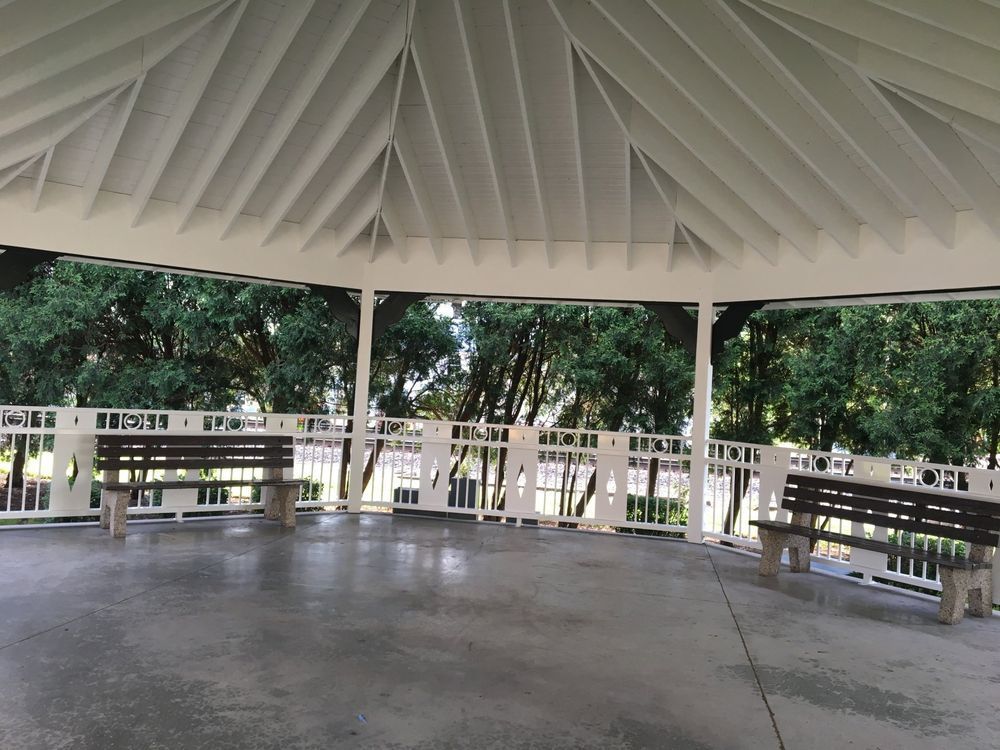 An empty gazebo with two benches underneath it
