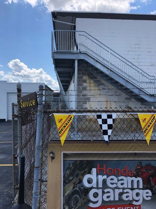 A honda dream garage is behind a chain link fence
