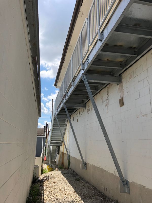 A metal staircase is attached to the side of a building.