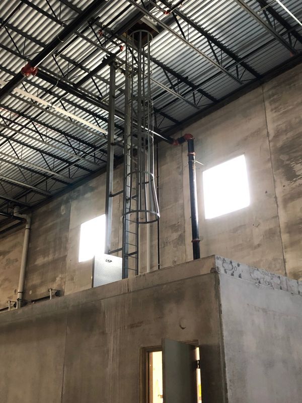 A ladder is hanging from the ceiling of a building.