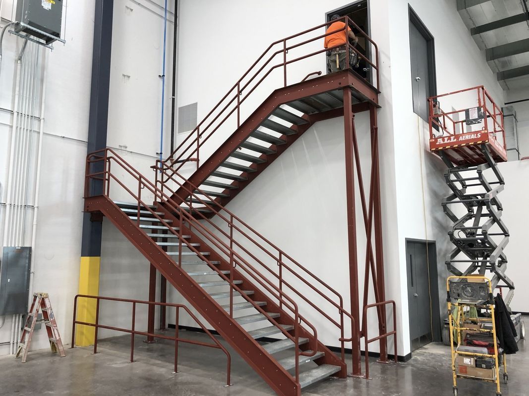A staircase in a building with a red railing