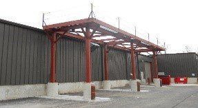 A metal structure is being built in front of a building.