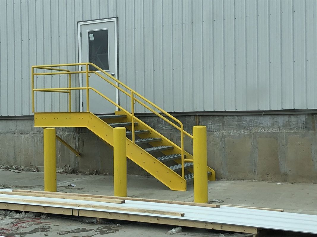 A set of yellow stairs leading up to a door
