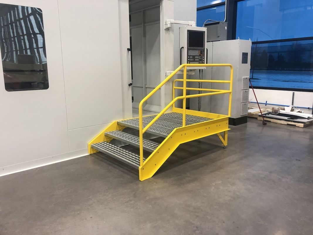 A yellow metal staircase with a yellow railing in a room.