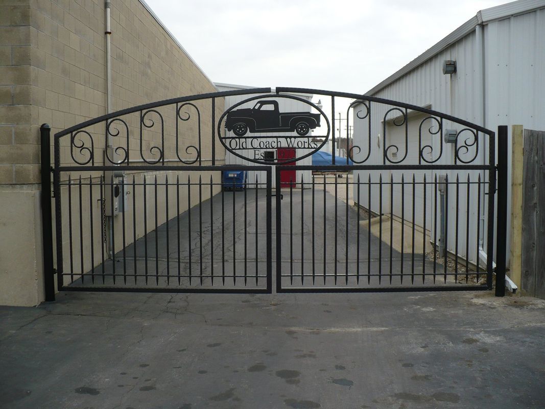 A wrought iron gate with a chevrolet logo on it