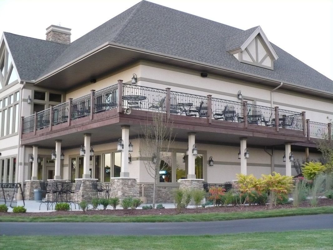 A large house with a balcony on the side of it