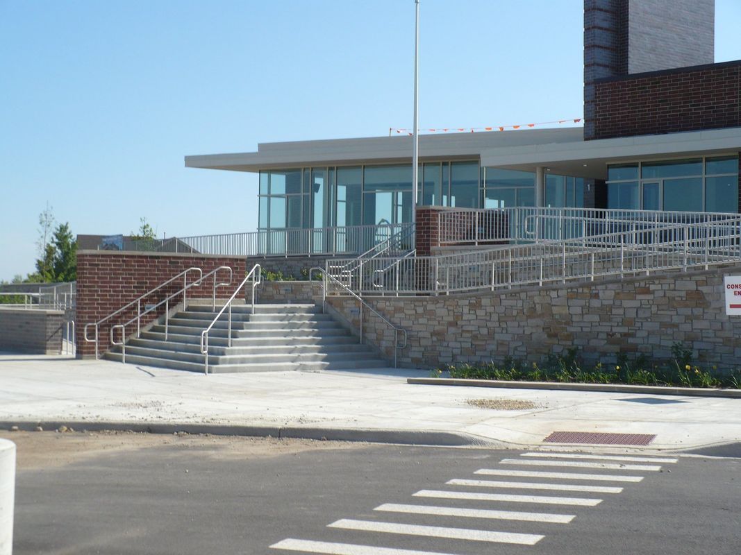 A building with stairs and a sign that says no parking