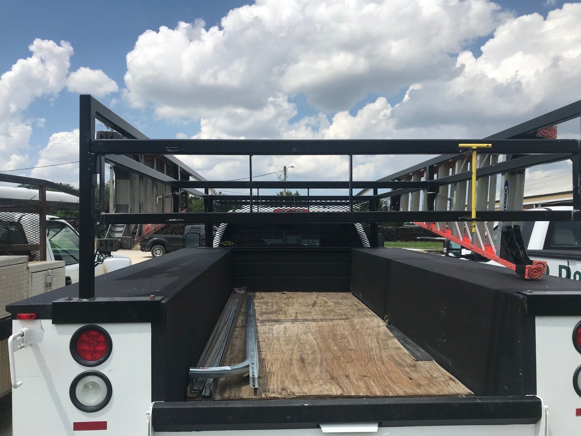 The back of a truck with a ladder attached to it.